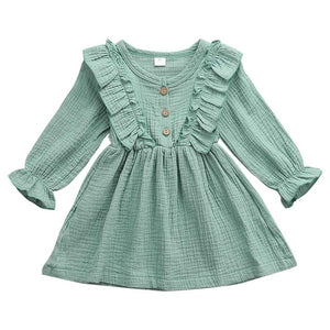 This dress is perfect for any day.  Your little girl will feel like a princess in our ruffle long sleeve dress.   PRODUCT DETAILS  Cotton  Knee-Length Crew neck, Full Sleeve ruffles at the shoulder and front and back A-Line, Three Wooden Buttons