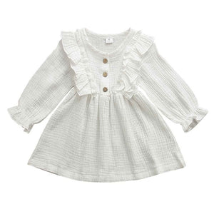 This dress is perfect for any day.  Your little girl will feel like a princess in our ruffle long sleeve dress.   PRODUCT DETAILS  Cotton  Knee-Length Crew neck Full Sleeve Ruffles at the shoulder and front and back A-Line Three Wooden Buttons