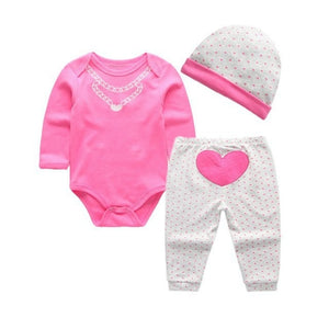 Graphic onesies are essential to every baby's wardrobe. This three-piece pink heart graphic long sleeve onesie, with pants and hat set, is great for any season.  PRODUCT DETAILS  Banded cuffs on cute pants with elastic waistband, Overlap shoulders on the onesie,  Crotch-snap buttons on the bodysuits allow fuss-free diaper changes 100% Cotton, Machine Washable 