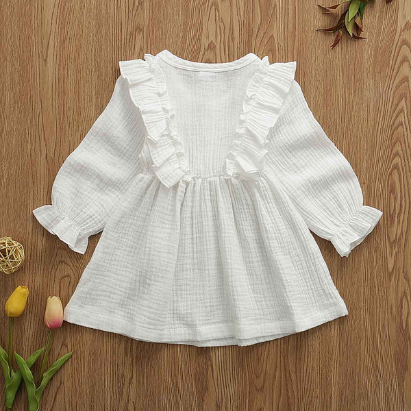 This dress is perfect for any day.  Your little girl will feel like a princess in our ruffle long sleeve dress.   PRODUCT DETAILS  Cotton  Knee-Length Crew neck Full Sleeve Ruffles at the shoulder and front and back A-Line Three Wooden Buttons